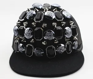 Close-up of black hip-hop cap with silver punk rivets and large faceted gemstones
