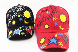 Detail view of colorful graffiti prints and embroidery on cotton baseball caps