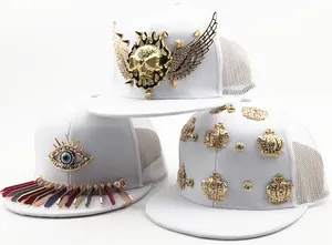 Close-up of white mesh baseball caps with punk gold skull and crown metallic studs