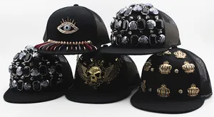 Close-up of assorted hip-hop kids' baseball caps with mesh back and metallic punk studs