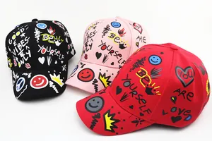 Detailed flat lay of graffiti baseball caps in black, pink, and red with colorful patterns