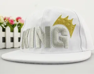 Close-up of 3D embroidery showing KING text and golden crown on a white snapback hat
