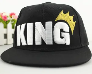 Close-up of black baseball cap with white KING embroidery and a golden crown detail