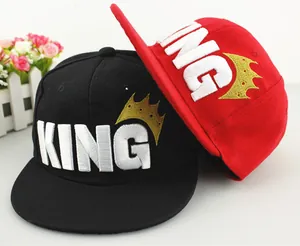 Close-up of kids baseball cap featuring 3D KING embroidery and gold crown detail