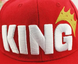 Detail shot of the 3D crown and KING embroidery on the red cotton kids' baseball cap