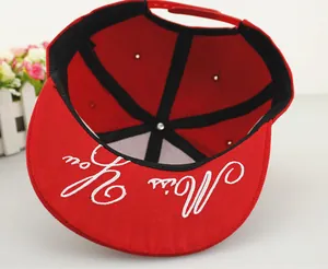 Detailed macro view of red baseball cap inner lining and Miss You embroidery under the brim