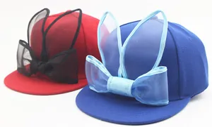Detail of kids baseball caps featuring mesh rabbit ears and decorative tulle bows