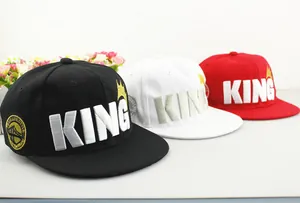 Detail view of KING embroidery and crown design on three colorful kids baseball caps