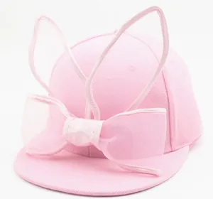 Detail of pink toddler baseball cap with bunny ears and a large sheer mesh bow decoration