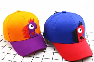 Detailed view of children's baseball caps featuring colorful cartoon dinosaur appliques