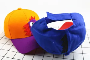 Detail of cartoon dinosaur baseball cap featuring adjustable velcro and colorful fabric
