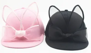 Detailed view of kids' baseball caps with pink and black mesh rabbit ears and bows
