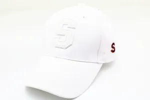 Detail of white cotton baseball cap showing 3D embroidered S and curved brim design