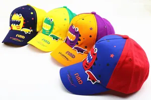 Detail view of four colorful kids baseball hats with cartoon dinosaur embroidery