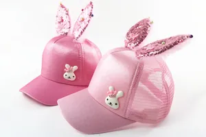 Detailed close-up of pink girls' mesh sun hats with sequined bunny ears and rabbit patch
