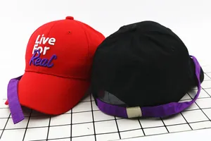 Detail of kids baseball caps with Live For Real embroidery and long purple adjustable straps