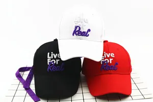 Detail view of cotton baseball caps in black, white and red with 3D embroidery