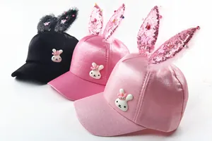 Close-up of mesh baseball caps with rabbit ears and sequin details for girls