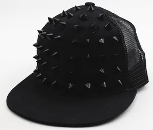 Detail of black baseball cap featuring punk style metal spikes and breathable mesh