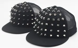 Detail of black trucker caps featuring silver metal cone studs and breathable mesh panels