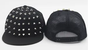 Detail of a black hip-hop cap with silver and gold cone studs and breathable mesh back