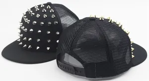 Close-up of black snapback caps with punk metal rivets and breathable mesh back