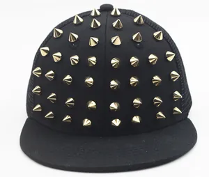 Close-up of golden cone studs on a black punk style mesh snapback hip-hop hat