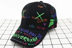 Close-up of black kids baseball cap with vibrant colorful graffiti print and curved brim