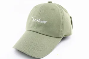 Detail of sage green baseball cap featuring white Forever embroidery and cotton twill texture