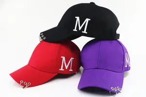 Détail de casquettes de baseball hip-hop avec broderie M et trois anneaux métalliques