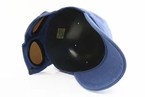 Detail view of cotton baseball cap inner lining and integrated pilot goggles design