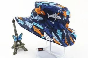 Detailed view of kids cartoon shark print sun hat with adjustable chin strap
