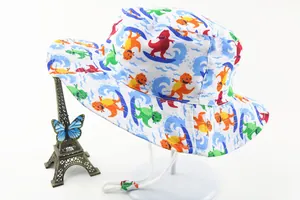 Detail of kids sun hat with colorful dinosaur surfing print and adjustable chin strap