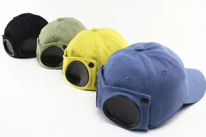 Detailed close-up of four kids' pilot baseball hats with iconic goggles and metal buttons