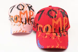 Detailed close-up of pink and red kids' baseball caps with street style graffiti print
