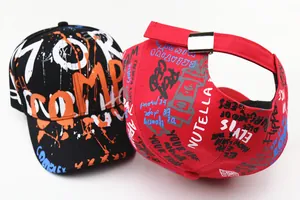 Detail view of graffiti baseball caps in red and black with metal adjustment buckle