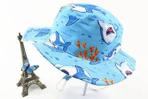 Detailed pattern of cartoon sharks and marine life on a blue wide-brim sun hat for kids