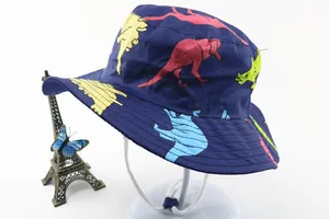 Detail of kids sun hat featuring colorful cartoon dinosaur prints and adjustable chin strap