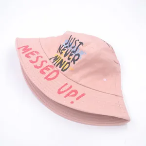 Detail of pink cotton bucket hat with bold red and black graffiti style printed text