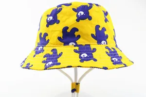 Detail of yellow cotton sun hat with purple bear patterns and white windproof strap
