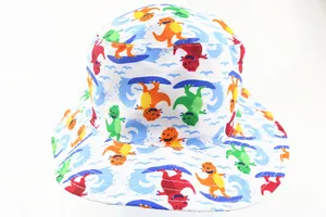 Detail of kids white sun hat featuring colorful cartoon dinosaur prints and blue wavy trim