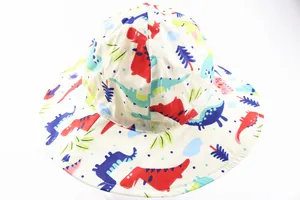 Detail of breathable cotton kids sun hat featuring colorful cartoon dinosaur patterns