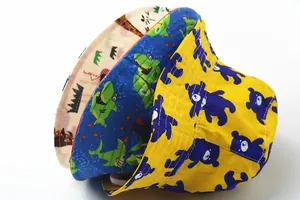 Detailed view of three cotton kids sun hats with bear and shark cartoon prints