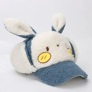 Detail of navy and cream plush winter hat with 3D rabbit ears and soft lamb wool texture