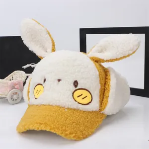 Close-up of yellow plush children baseball cap with cute bunny ears and sherpa texture