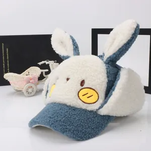 Detail of plush blue and white winter hat with rabbit ears and cute cartoon face