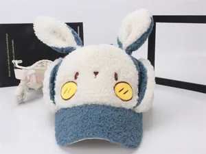 Detail view of the thick sherpa fleece rabbit ears and cute face embroidery on the blue cap