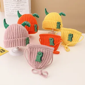 Detailed knit texture of dinosaur-themed kids hat and matching bag set in vibrant colors