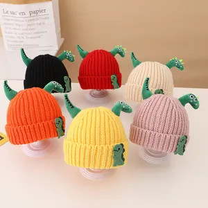Close-up of knit hats for kids with dinosaur accents in six different vibrant colors