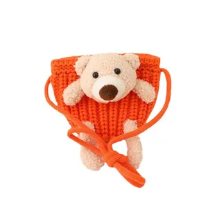 Cute bright orange knitted mini crossbody bag with plush bear mascot for toddler fashion